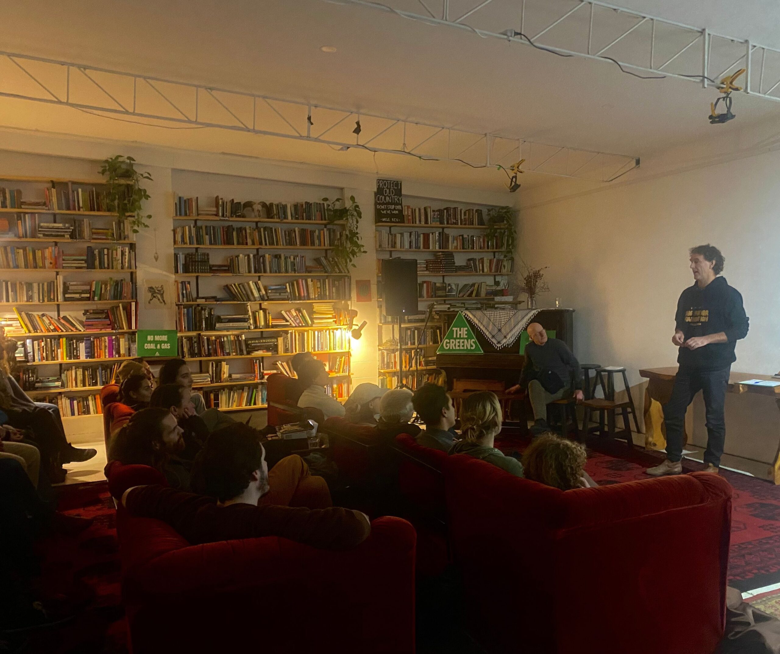 Photograph of people sitting on couches at Black Spark, listening to a panel speak